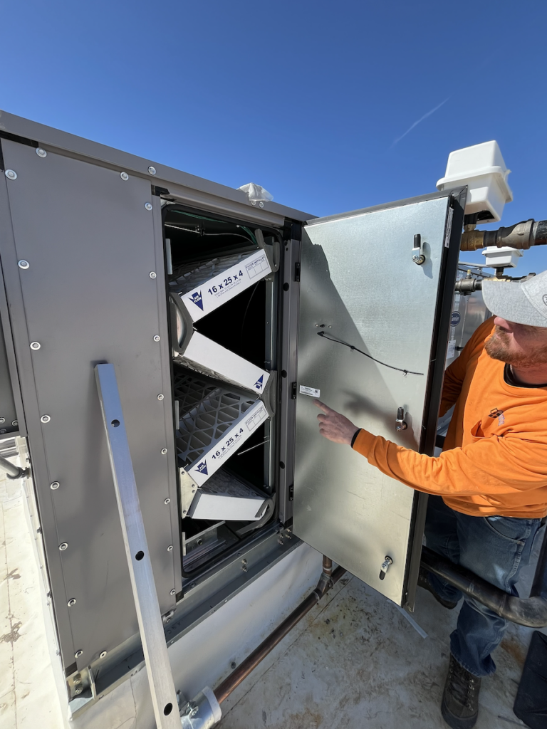 Colorado Controls technician performing maintenance on a building automation system for building owner
